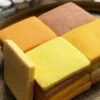 A mosaic of handcrafted citrus cookies showing a natural gradient of warm, sunset tones.