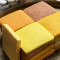 A mosaic of handcrafted citrus cookies showing a natural gradient of warm, sunset tones.