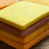 A mosaic of handcrafted citrus cookies showing a natural gradient of warm, sunset tones.