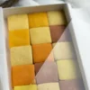 A mosaic of handcrafted citrus cookies showing a natural gradient of warm, sunset tones.