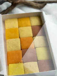 A mosaic of handcrafted citrus cookies showing a natural gradient of warm, sunset tones.